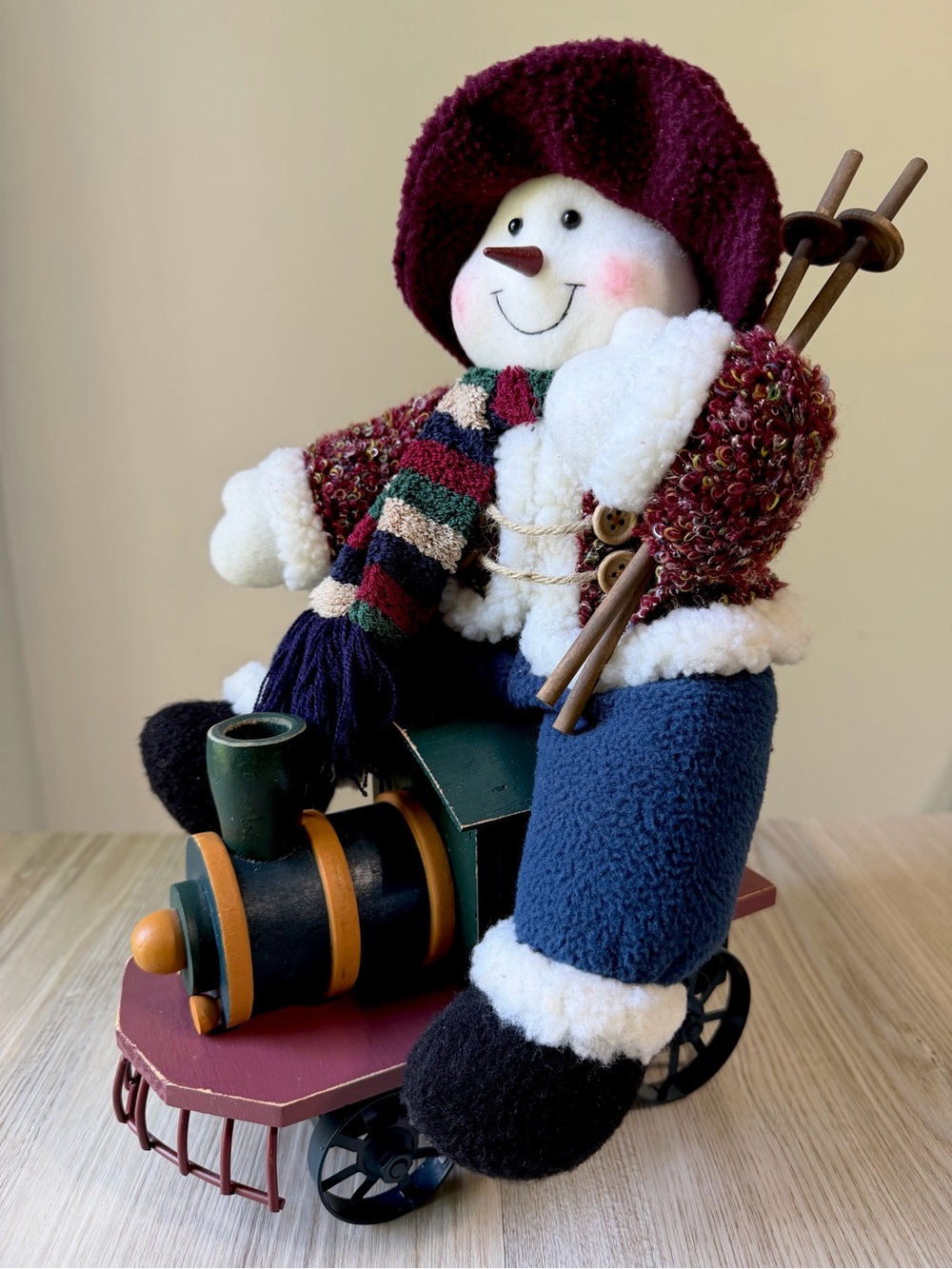 Vintage Plush Snowman Christmas Decoration on a Wood and Metal Holiday Train